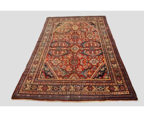 Mahal carpet, north west Persia, early 20th century, 11ft. 10in. X 7ft. 5in. 3.60m. X 2.26m. Overall wear with moth damage in