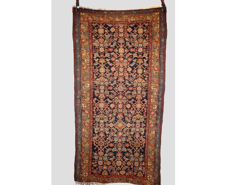 Two rugs, the first: Hamadan rug, north west Persia, early 20th century, 6ft. 9in. X 3ft. 6in. 2.05m. X 1.07m. Herati design 