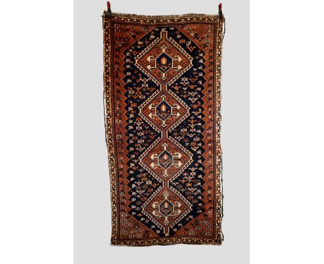 Two Fars rugs: Qashqa'i Confederacy, mid-20th century, the first, 8ft. 2in. X 4ft. 2in. 2.49m. X 1.27m. Dark blue lozenge sha