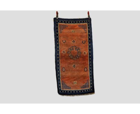 Tibetan khaden (sleeping or sitting rug), Inner Asia, late 19th century, 4ft. 11in. X 2ft. 7in. 1.50m. X 0.79m. Overall even 