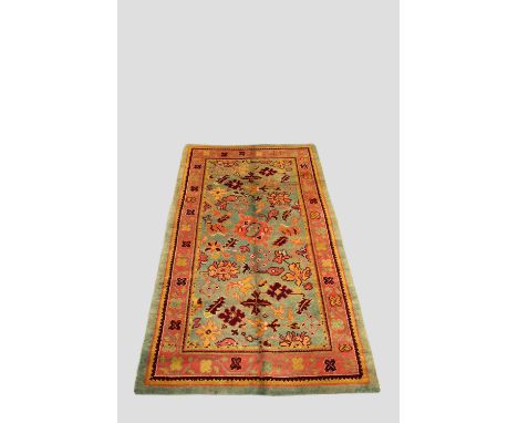 Donegal carpet, north west Ireland,  first half 20th century, 9ft. 3in. X 4ft. 11in. 2.82m. X 1.50m. Pale green field with al