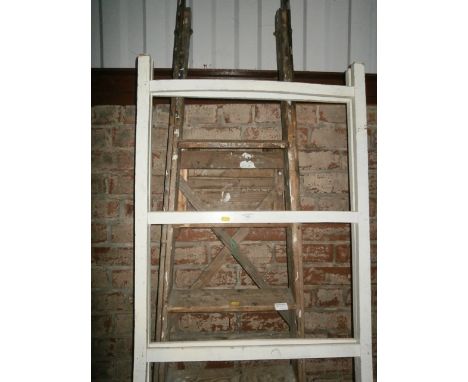 pair of wooden step ladders and a maiden