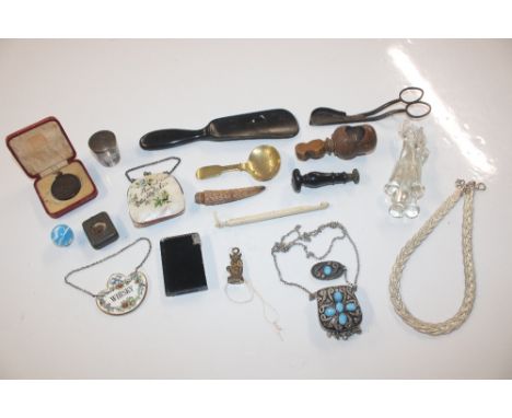 A box containing cigarette lighter, shoe horn, glass stirrers, seal etc.