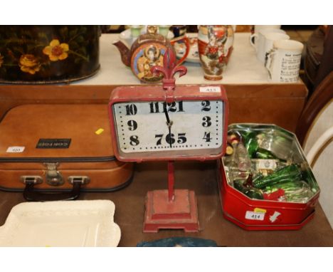 A small red metal cased retro type clock