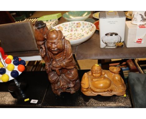 An Oriental carved hardwood figural table lamp; and a seated figure of Ho Tei