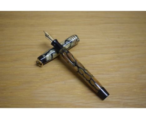 A Parker Duofold Lady Deluxe button fill fountain pen in black and pearl with three gold bands to the ring top cap having  Pa