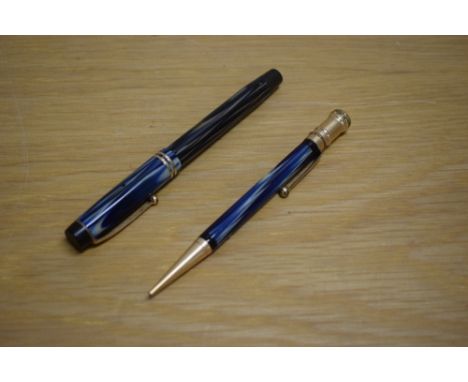 A Parker Duofold Special Steamlined Short button fill fountain pen and propelling pencil in blue and cream with two cap bands