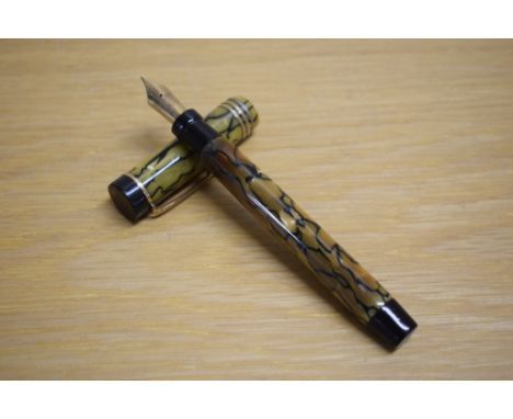 A Parker Duofold Special Lucky Curve button fill fountain pen in black and pearl with three gold bands to the cap having Park