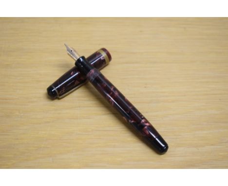 A Parker Challenger button fill fountain pen in black and red marble with one broad gold cap band having Parker 14K England 2