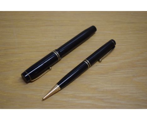 A Parker Duofold Special Short button fill fountain pen and propelling pencil in black with two bands to the cap having Parke