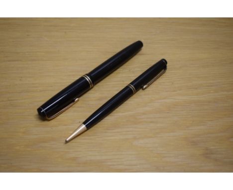 A Parker Duofold Victory button fill fountain pen and propelling pencil in black with two gold cap bands having Parker 14k Pe