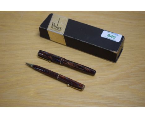 A  boxed Parker Moderne button fill fountain pen and Propelling pencil in burgundy marble with blue veining with single gold 