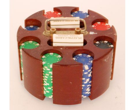 A set of backgammon chips with two packs of cards in revolving holder