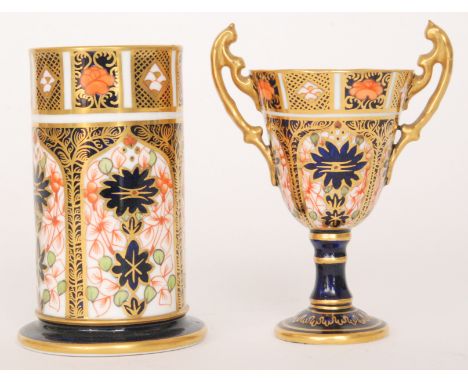 Two pieces of Royal Crown Derby Imari pattern 1128 comprising a twin handled pedestal cup and a cylindrical spill vase, both 