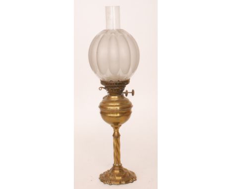 A Victorian brass oil lamp with spiral foliate pedestal and base together with shade and chimney, height 62cm