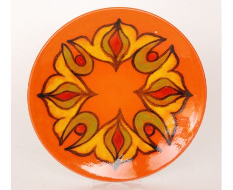 A Poole Pottery Delphis charger decorated with a yellow and green abstract band against a bright orange ground, printed mark 