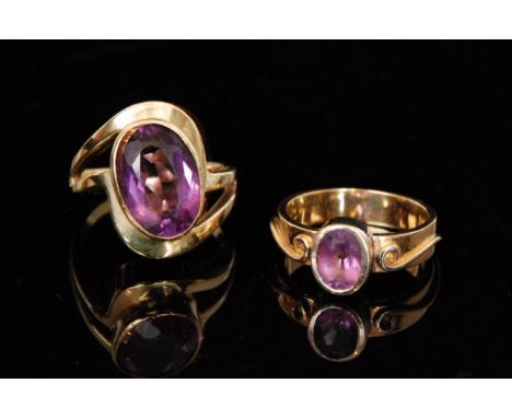 A 15ct amethyst dress ring, the S shaped head united by an oval facet cut collar set amethyst, weight 6g, stamped together wi