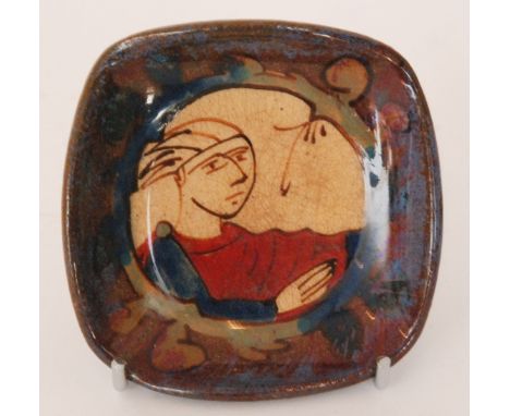 An early 20th Century French studio pottery pin dish of square form decorated with a hand painted head and shoulders portrait