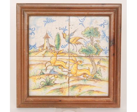 A 19th Century framed French Faience tile panel comprising four 6" tiles decorated with rabbits running in a landscape with a