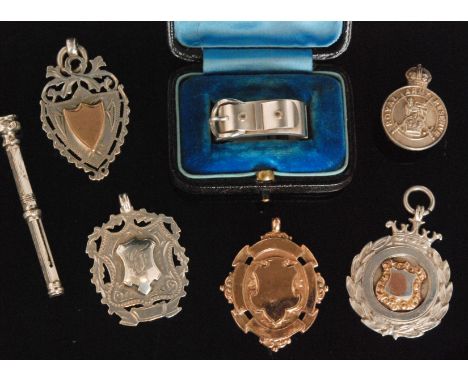 An early 20th Century 9ct rose gold gentleman's fob, weight 11g, together with three hallmarked silver fobs, one engraved H.M