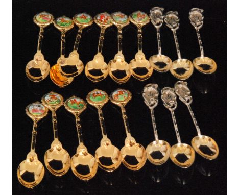 Two sets of six modern hallmarked silver gilt teaspoons, each having applied enamelled hunting scene terminal, Sheffield 1980