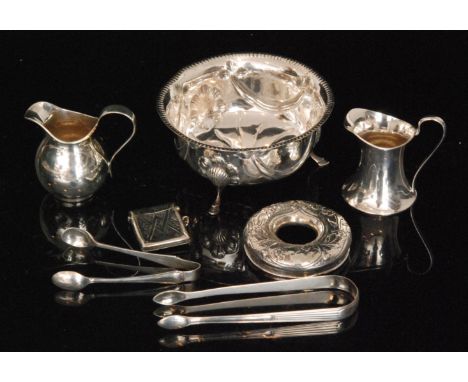 A parcel lot of assorted hallmarked silver items to include a sugar basin, two cream jugs, two pairs of sugar tongs, a powder