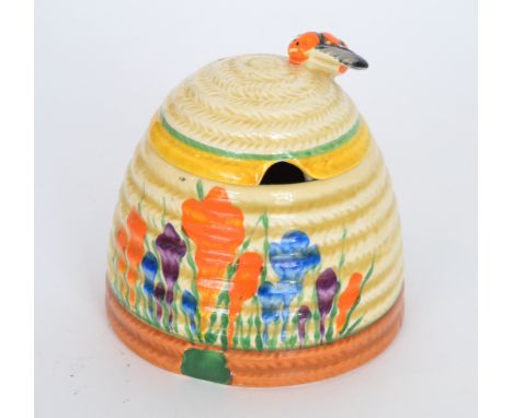 A large Clarice Cliff Crocus Beehive honey pot circa 1930 hand painted with crocus sprays between yellow, green and brown ban
