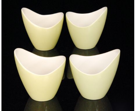 A set of four Poole Pottery Freeform elliptical vases, shape 350, designed by Alfred Read, each decorated in a pale green gla
