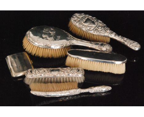 A selection of five hallmarked silver backed hand brushes, various designs to include Reynolds Angels, foliate scroll embosse