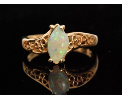 A modern 14ct opal dress ring with pierced shoulders tapering to plain band, weight 2.7g, ring size L