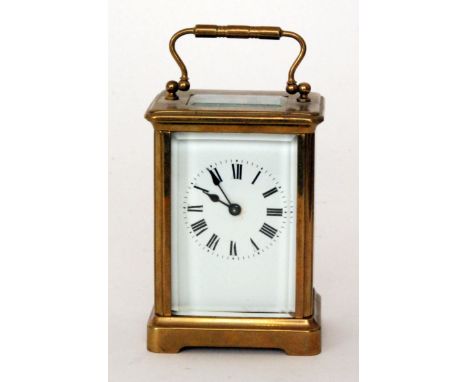 A late 19th Century French brass carriage clock with white enamel dial in glazed case, height 11cm