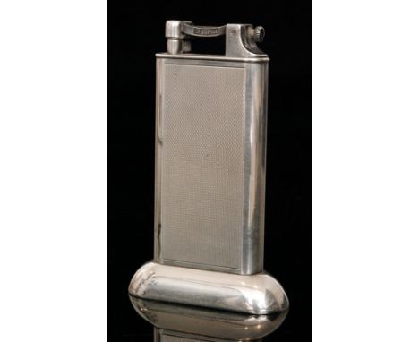 A silver plated Dunhill tallboy table lighter with rectangular engine turned shaped body, the hinged cover signed 'Dunhill', 