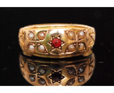 A late 19th Century 15ct hallmarked ruby and seed pearl seven stone boat shaped ring, central ruby flanked with four pearls t