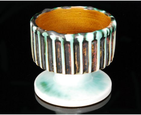 A Poole Pottery pedestal bowl by Guy Sydenham, the upper body with linear band carving and decorated with a green oxide over 