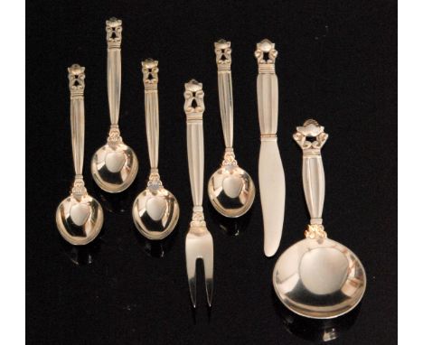 A Danish Georg Jensen sterling Acorn pattern silver caddy spoon, together with four small coffee spoons, a lemon fork, and a 