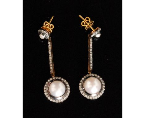 A pair of Edwardian style silver gilt diamond and split pearl drop earrings, pearl terminals within diamond set border and co