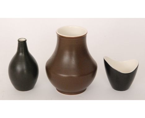 Three pieces of Poole Pottery Freeform comprising a shape 688 bottle vase decorated in a black glaze, a black glaze shape 350