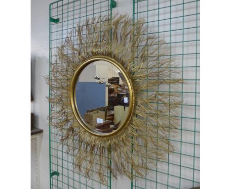 A contemporary circular gilt framed mirror 