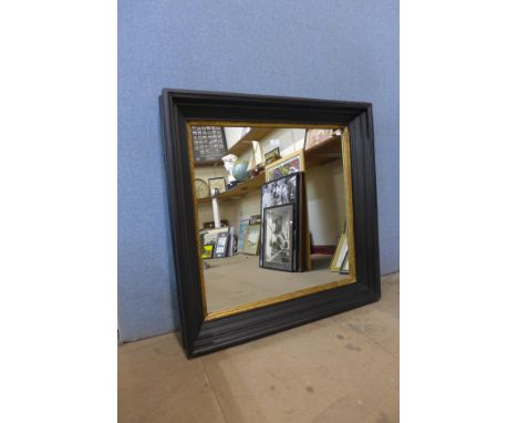 An ebonised and parcel gilt framed mirror 