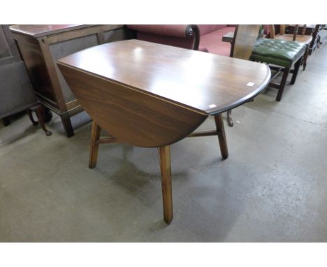 An Ercol Golden Dawn elm drop leaf table 