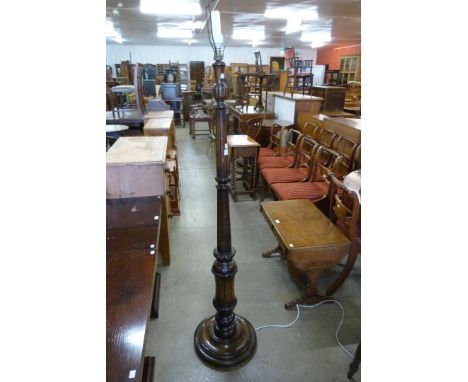 A carved oak standard lamp 