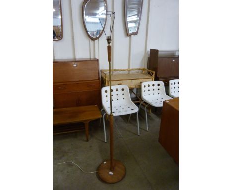 A teak and brass standard lamp 