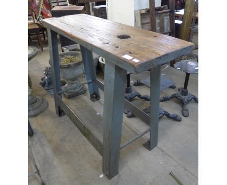 An industrial steel and plank top work bench 
