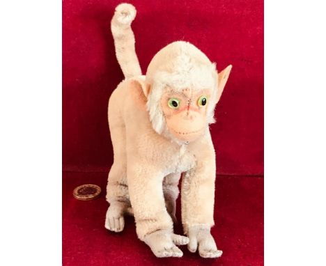 OLD PLUSH STEIFF MONKEY WITH FELT FACE AND HANDS AND FEET, GREEN AND BLACK GLASS EYES, APPROXIMATELY 14cm FLOOR TO HEAD HEIGH