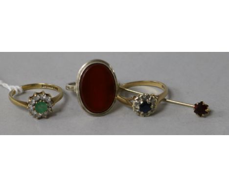 Two 9ct gold gem set rings, one other ring and a stick pin.