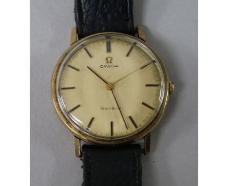 A gentleman's yellow metal Omega manual wind wrist watch.