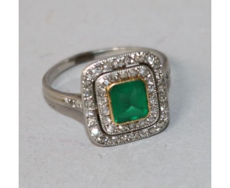 A white metal, emerald and diamond tablet cluster ring, size K.