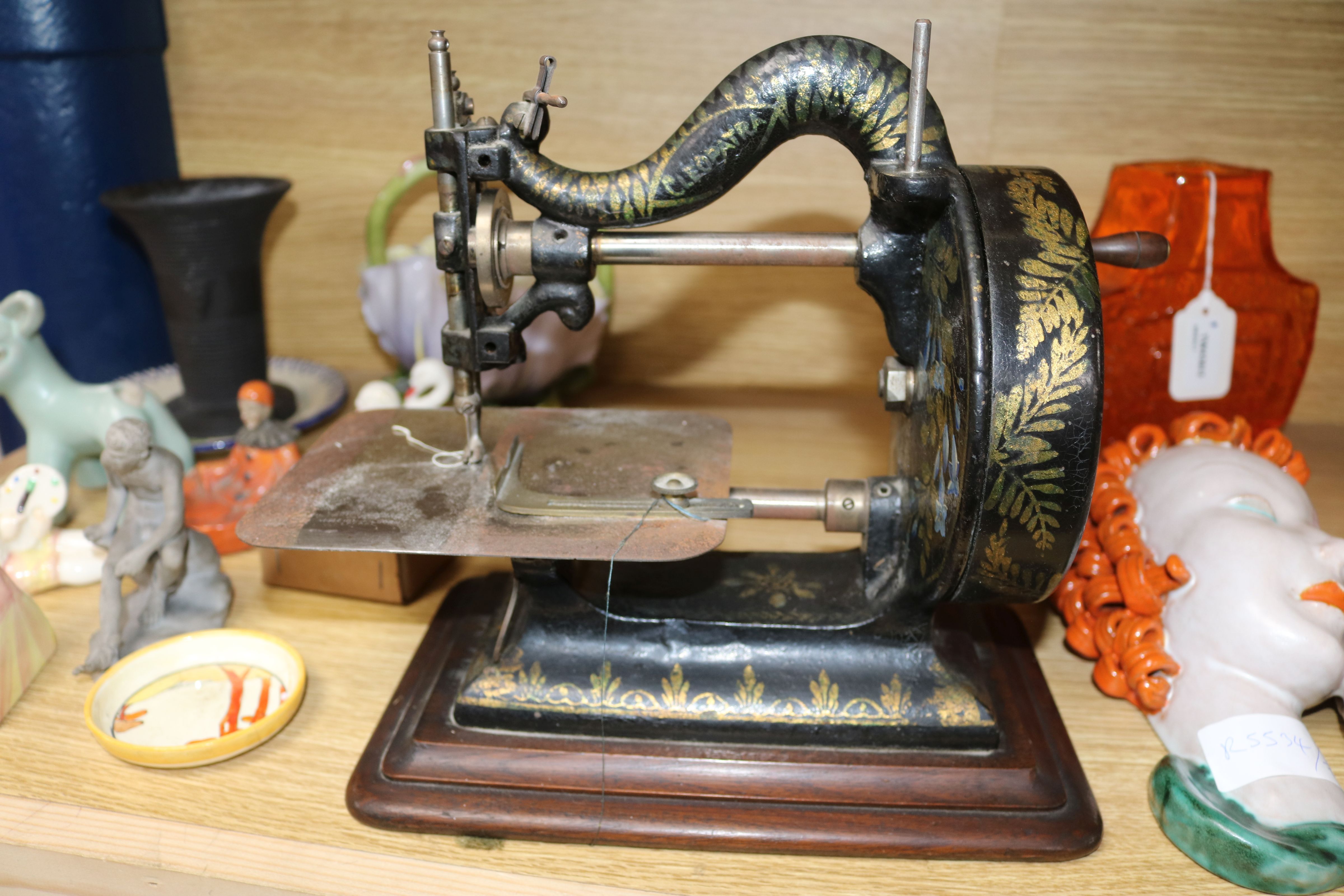 A Victorian Newton Wilson & Co sewing machine, with contemporary manual