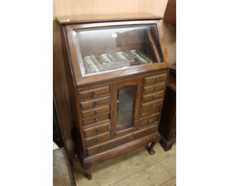 A 1920's walnut opticians's cabinet W.73cm