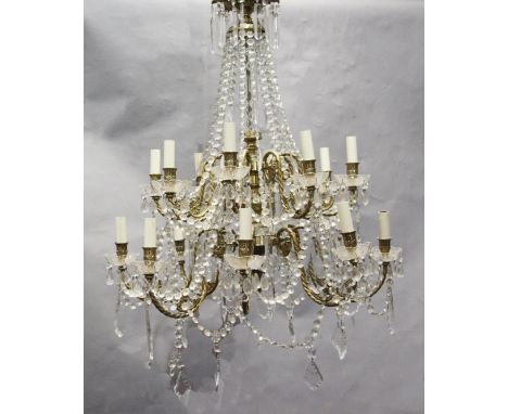 An 18th century style gilt brass and glass sixteen light chandelier, hung with lustre and tear shaped drops, drop 3ft 6in. di